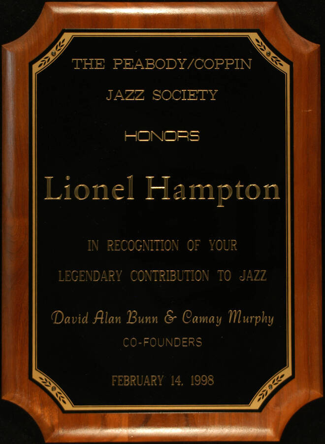 Plaque. 15"x11" Walnut finish plaque with engraved plate To Lionel Hampton from the Peabody/Coppin Jazz Society. David Alan Bunn and Camay Murphy, Co-founders. Baltimore, MD, Feb. 14, 1998
