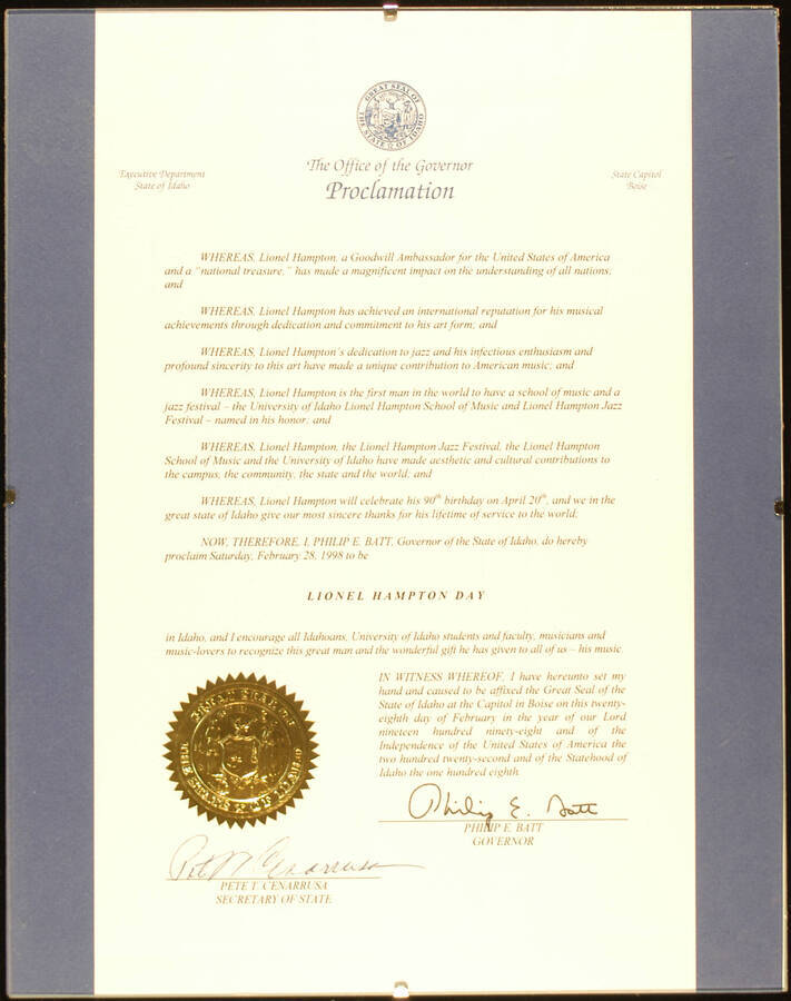 Framed Certificate. 14"x11" Frame holding a proclamation with gold foil seal on blue background under glass State of Idaho proclaims February 28, 1998 as Lionel Hampton Day. Philip E. Batt, Governor and Pete T. Cenarrusa, Secretary of State. Boise, ID, Feb. 28,1998