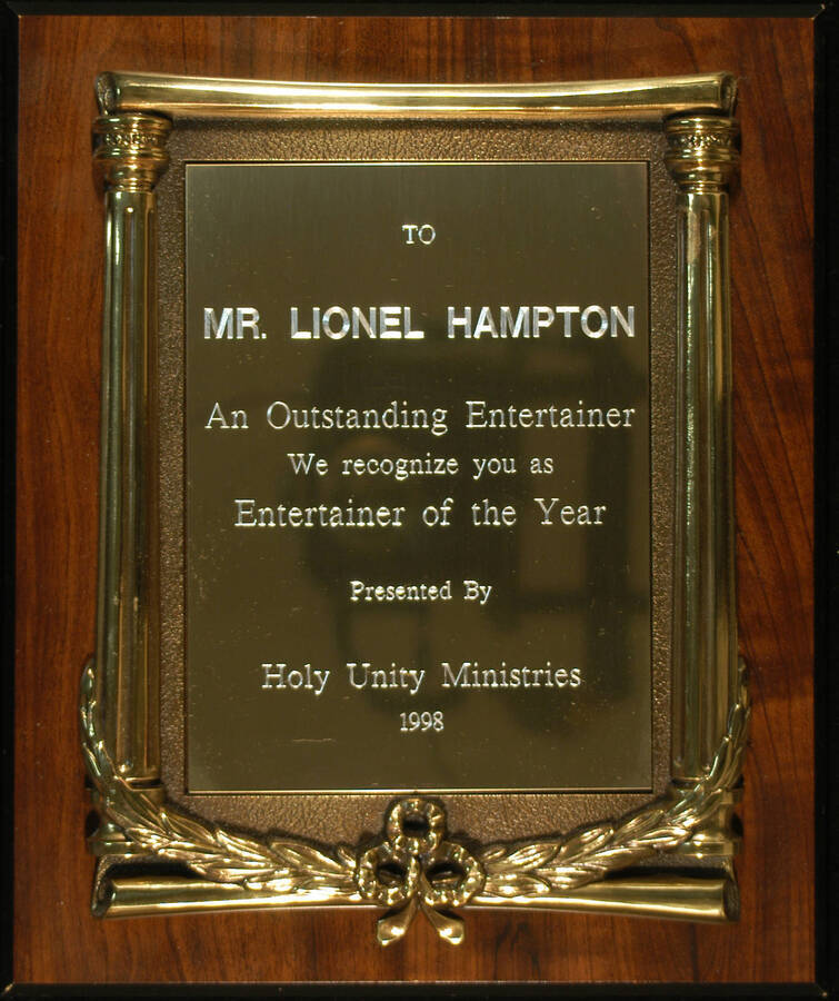 Plaque. 12"x10" Wood finish plaque with engraved plate inside casting Entertainer of the Year presented to Lionel Hampton by the Holy Unity Ministries. 1998