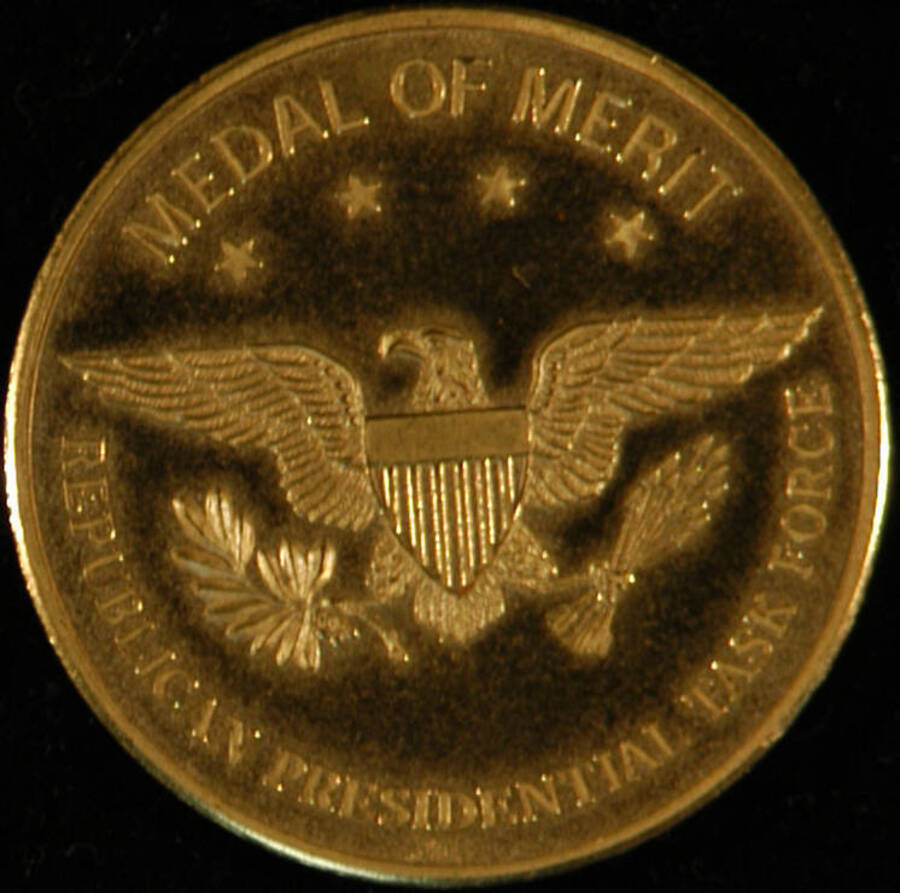 Medal. 1 1/2" Gold medal depicting the bald eagle with its wings outstretched encircled by the words "Medal of Merit" "Republican Presidential Task Force." It is inside a presentation box