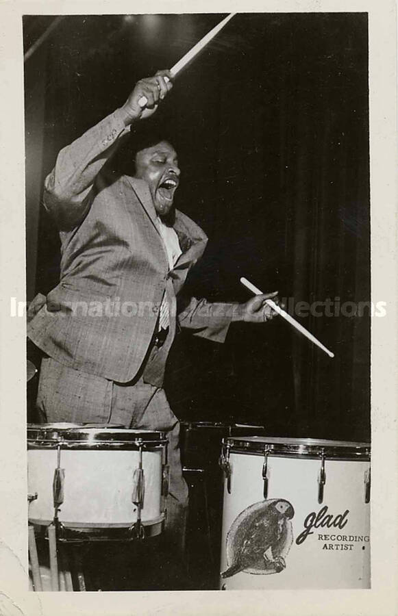 5 1/2 x 3 1/2 inch promotional photograph in the format of postcard. Lionel Hampton. Printed on the back: Lionel Hampton; Exciting International Artist; Glad Record Recording Artist; King of the Vibes, Master of the Drums
