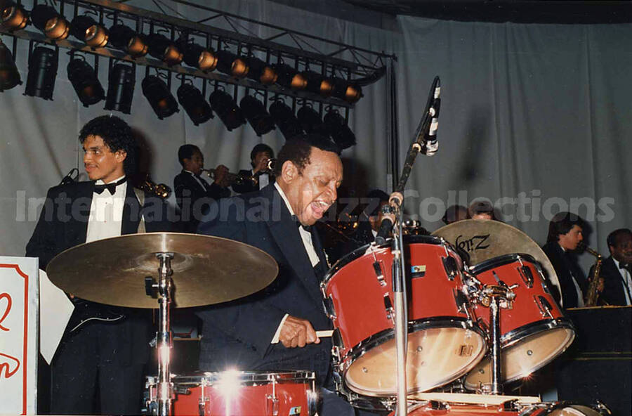 3 3/4 x 5 1/2 inch photograph. Lionel Hampton performing on the drums with orchestra