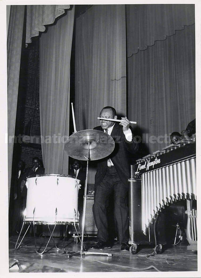 7 x 5 inch photograph. Lionel Hampton playing the drums on the occasion of his receiving the Certificate of Distinguished Honorary Alumnus from Langston University for outstanding performance in the field of the performing arts. Langston, OK