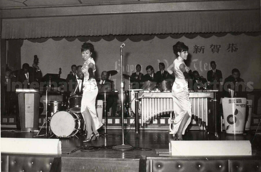 3 1/2 x 5  inch photograph. Lionel Hampton's band with two unidentified women dressed in Japanese costume, dancing in Japan