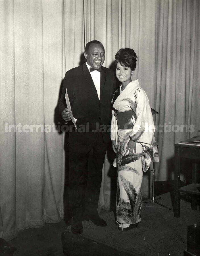 10 x 8 inch photograph. Lionel Hampton with unidentified woman dressed in Japanese costume [Miyoko Hoshino?]