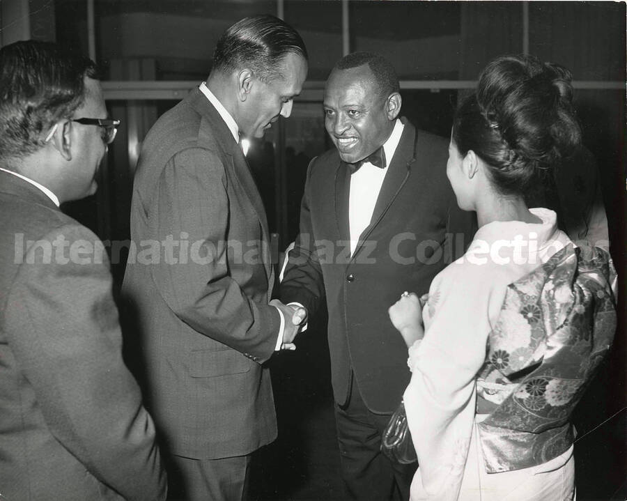 8 x 10 inch photograph. Lionel Hampton with unidentified persons, including a woman dressed in Japanese costume [Yukari Kuroda?]
