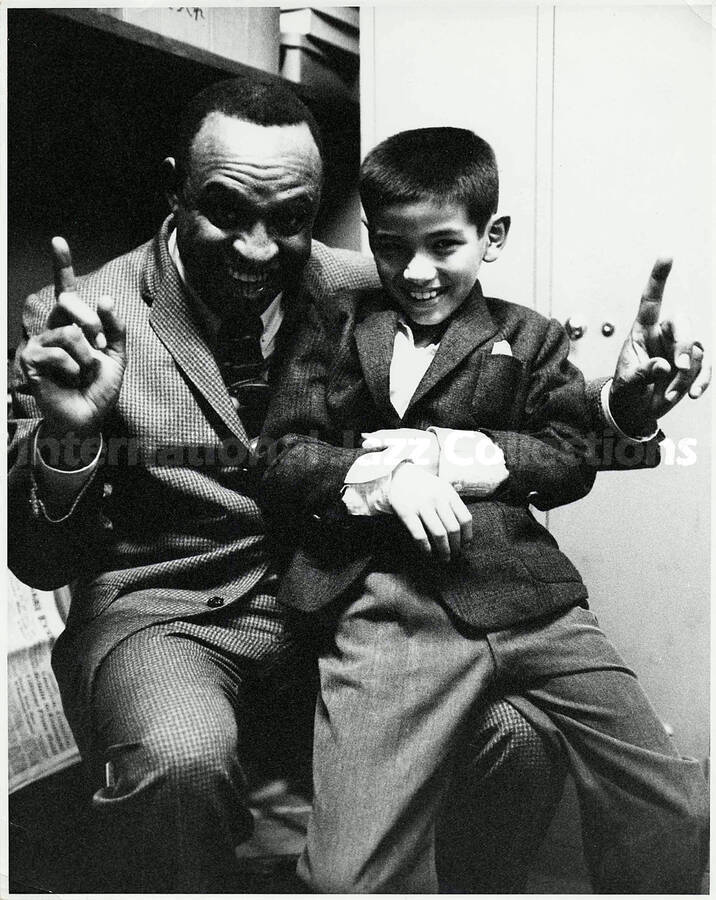 10 x 8 inch photograph. Lionel Hampton with a boy [in Japan?]