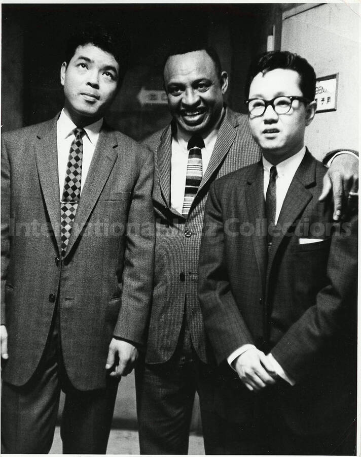 10 x 8 inch photograph. Lionel Hampton with two unidentified men [in Japan?]