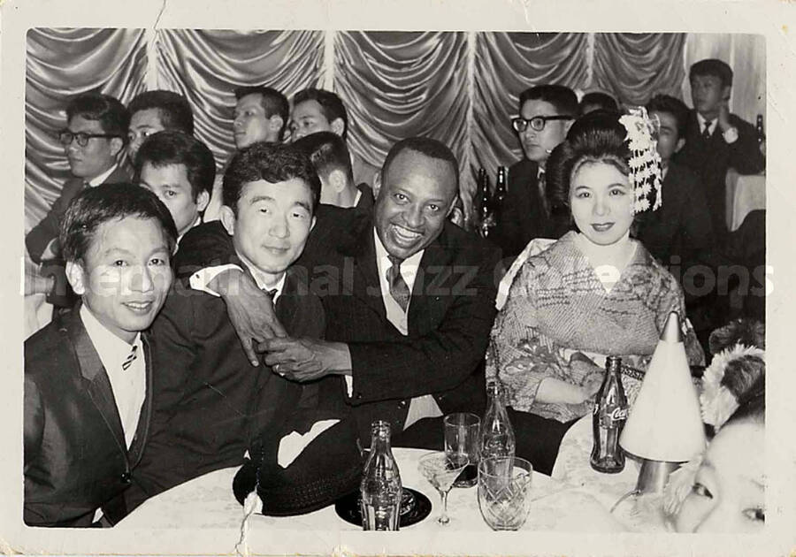 3 1/2 x 5 inch photograph. Lionel Hampton with unidentified persons including a woman dressed in Japanese costume [in Japan]