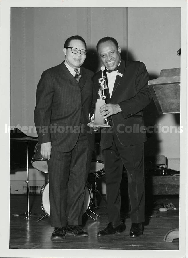 7 x 5 inch photograph. Lionel Hampton holding a trophy with unidentified man