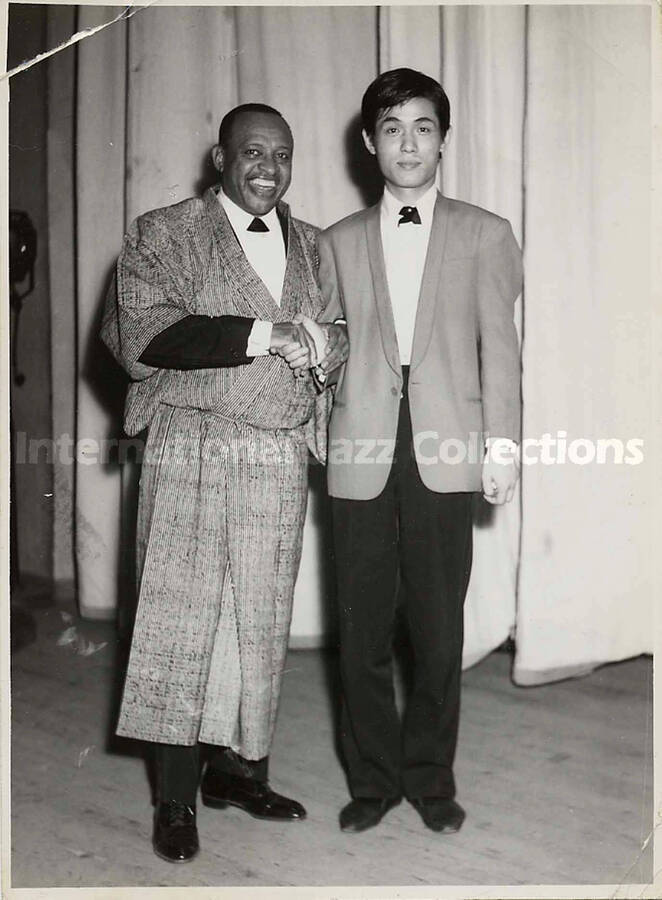 6 1/2 x 4 1/2 inch photograph. Lionel Hampton with unidentified man, [in Japan]