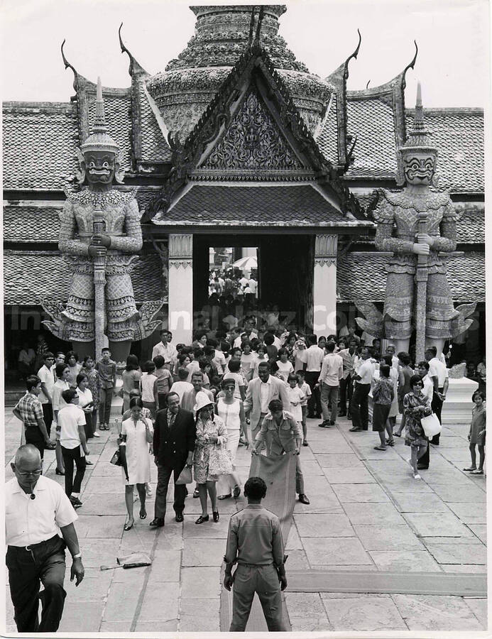 10 x 8 inch photograph. Gladys and Lionel Hampton in Thailand. Typewritten note on the back of the photograph reads: Lionel Hampton and Mrs. Hampton come to view the Temple of the Emerald Buddha during a Sunday sightseeing tour of Bangkok