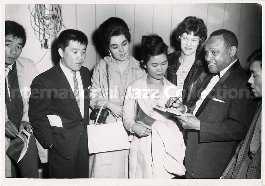5 x 7 inch photograph. Lionel Hampton autographing for fans [in Japan]