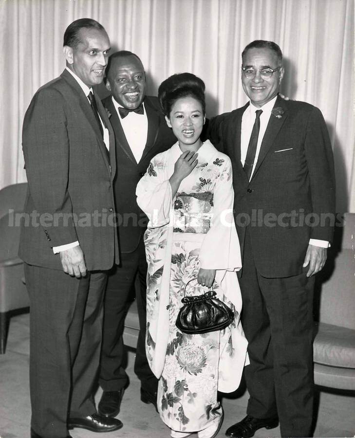10 x 8 inch photograph. Lionel Hampton with unidentified persons, including a woman dressed in Japanese costume [Yukari Kuroda?]