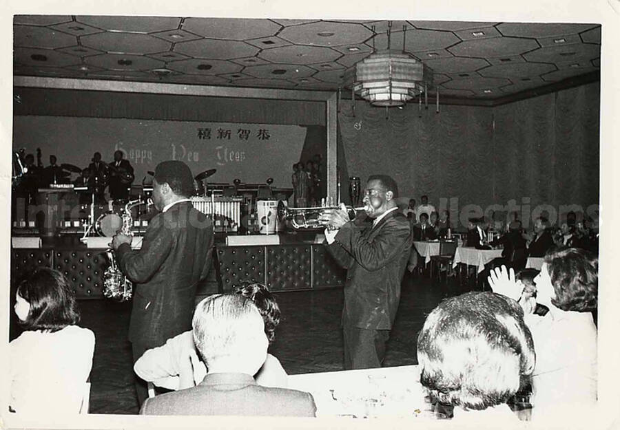3 1/2 x 5  inch photograph. Lionel Hampton's band in Japan, with musicians moving among an audience