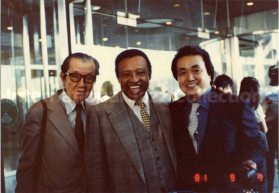 3 1/4 x 4 1/2 inch photograph. Lionel Hampton with unidentified men [in Japan?]