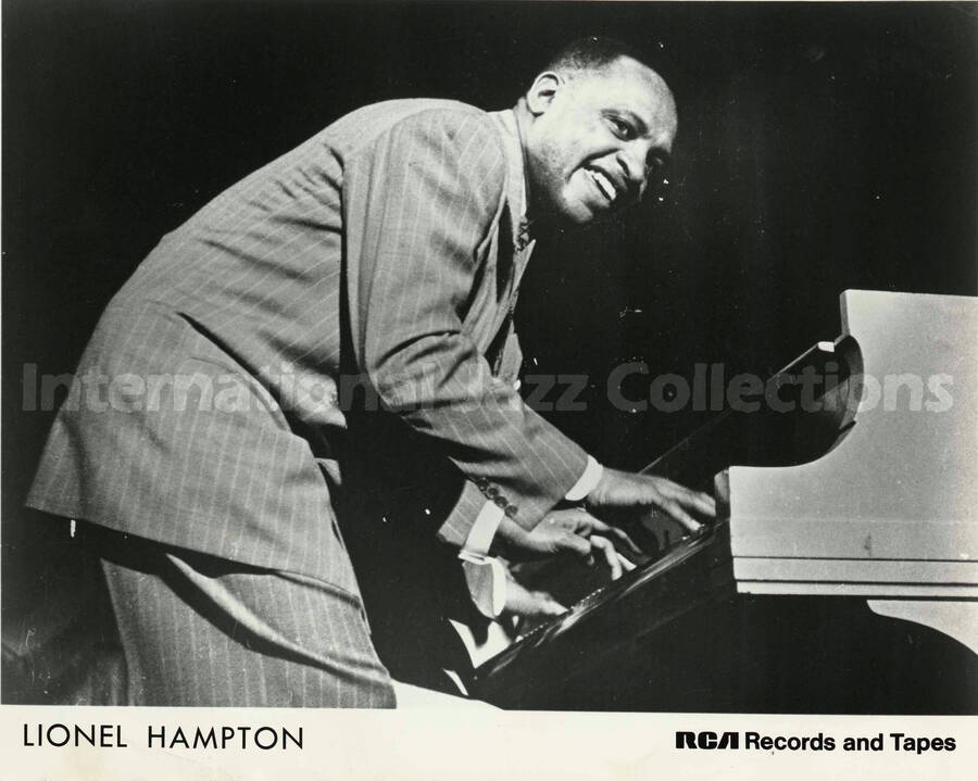 8 x 10 inch promotional photograph. Lionel Hampton playing the piano