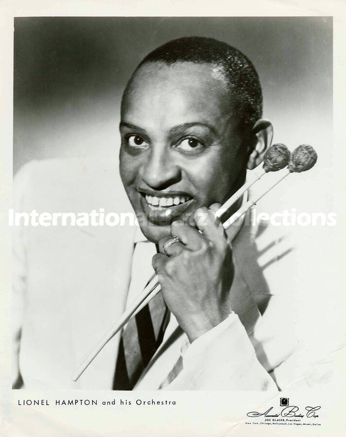 10 x 8 inch promotional photograph. Lionel Hampton holding two mallets. Inscribed at the bottom of the photograph: Lionel Hampton and His Orchestra