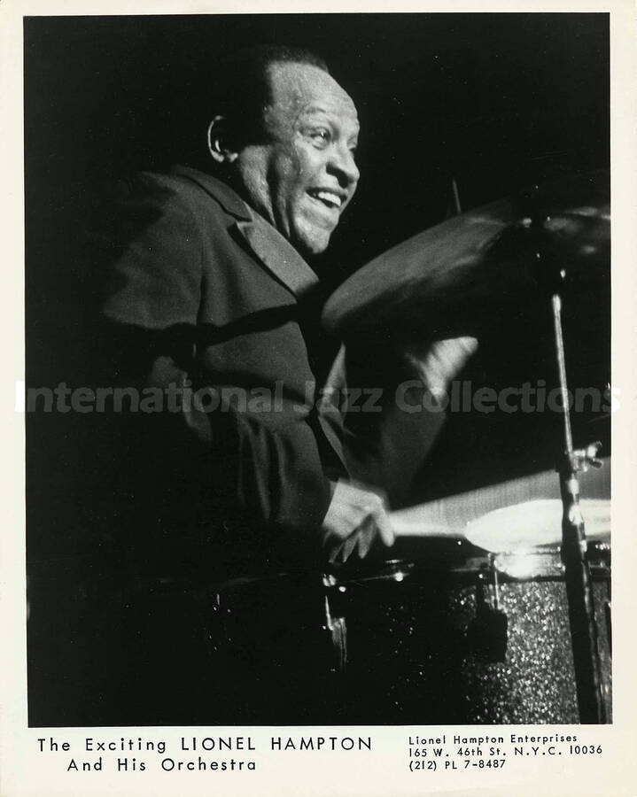 10 x 8 inch promotional photograph. Lionel Hampton playing the drums. Inscribed at the bottom of the photograph: The Exciting Lionel Hampton and His Orchestra