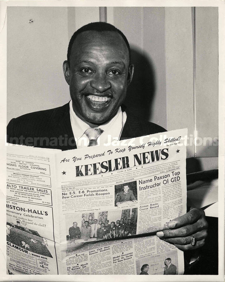 10 x 8 inch photograph. Lionel Hampton is pictured holding a copy of the newspaper Keesler News, during his visit to the Keesler Air Force Base, in Biloxi, MS