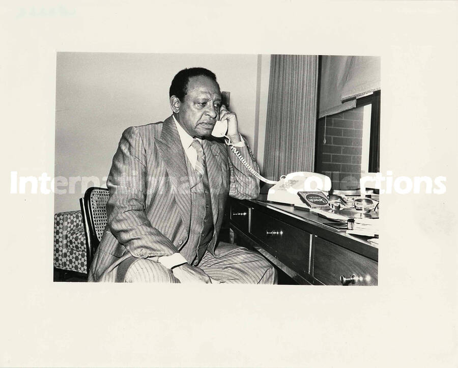 8 x 10 inch photograph. Lionel Hampton on the telephone with a pack of Sherman's Phantom cigarette on the table
