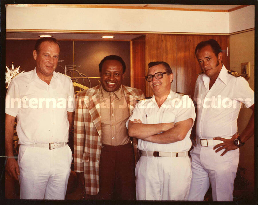 8 x 10 inch photograph. Lionel Hampton poses with three unidentified men in Navy uniform