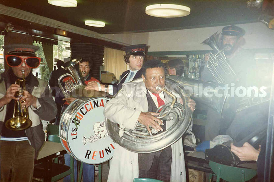 3 1/2 x 5 1/2 inch photograph. Lionel Hampton with the band Les Buccinateurs Reunis in a restaurant in [Bordeaux], France