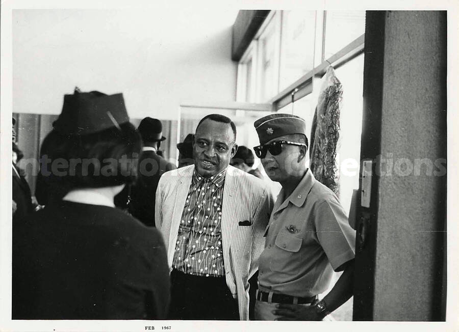 4 3/4 x 6 1/2 inch photograph. Lionel Hampton with unidentified persons