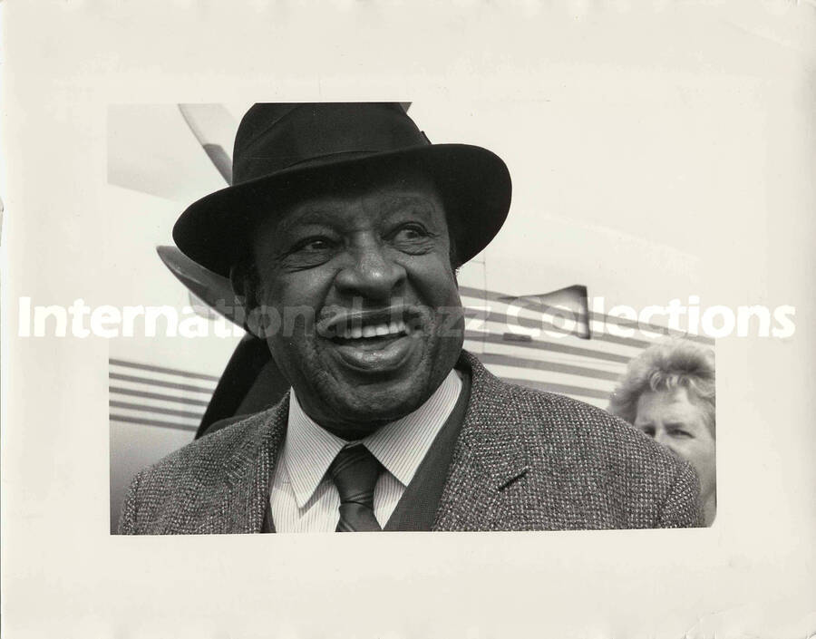 9 1/2 x 12 inch photograph. Lionel Hampton standing outside a plane