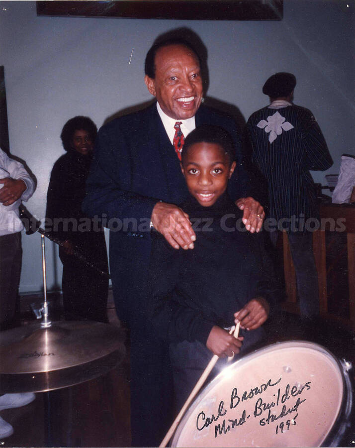 10 x 8 inch photograph. Lionel Hampton with a boy. This photograph is dedicated to Lionel Hampton from Carl Brown, Mind-Builders student