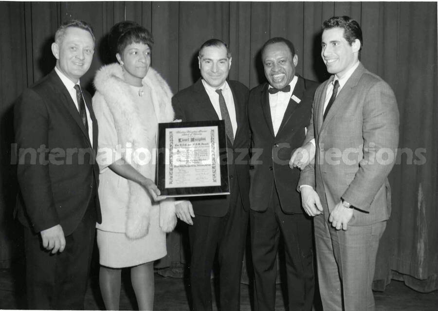 5 x 7 inch photograph. Lionel Hampton receives the Honorary Lifetime Member of the Faculty from the Harlem Hospital Center School of Nursing, at the New York City's Town Hall. New York, NY