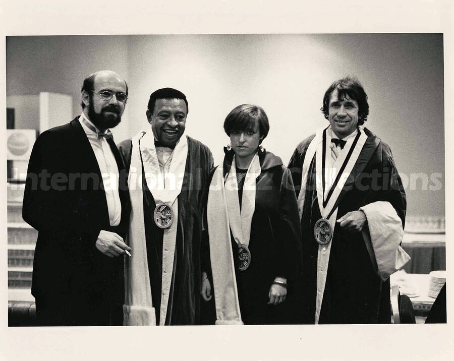8 x 10 inch photograph. Lionel Hampton with a medal on his neck poses with three unidentified persons, two of whom received the same award