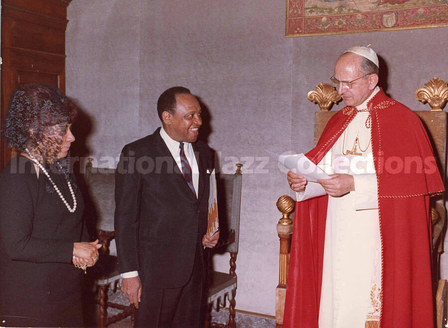 7 x 9 1/2 inch photograph. Gladys and Lionel Hampton at private audience with Pope Paul VI [at the Vatican], Rome. Stamped on the back of the photograph: Dorothy Ross Associates, New York