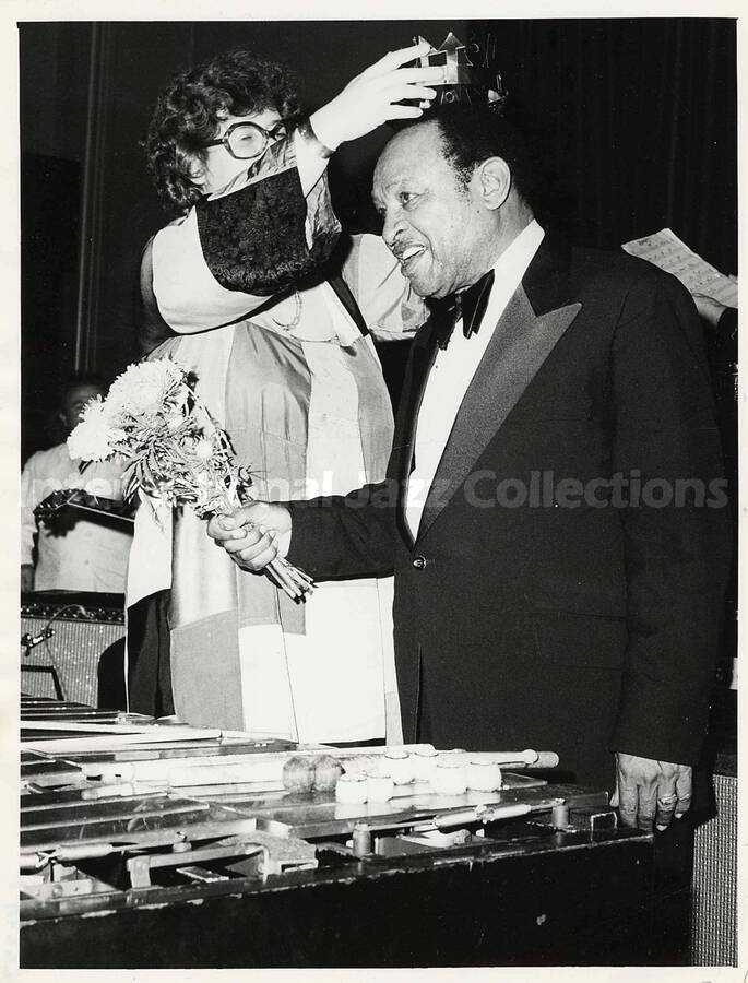 7 x 9 1/2 inch photograph. Lionel Hampton wearing a paper crown
