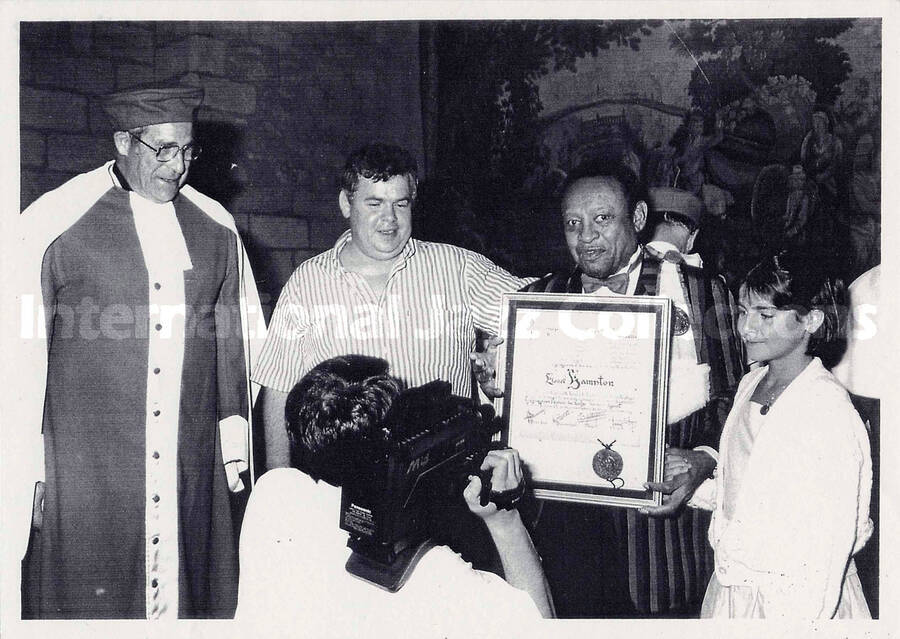 6 x 8 1/2 inch photograph. Lionel Hampton with Christian Dupin, on the occasion of his receiving a certificate [in France?]. This is a photocopy of a photograph