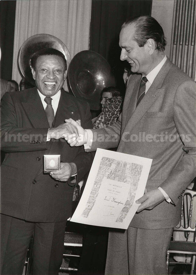 9 1/2 x 6 1/2 inch photograph.  Lionel Hampton receives the medal of the City of Paris from Jacques Chirac, Mayor of the city