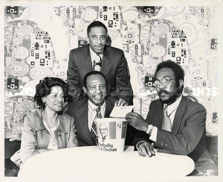8 x 10 inch photograph. Lionel Hampton with three unidentified persons endorsing Kentucky Fried Chicken
