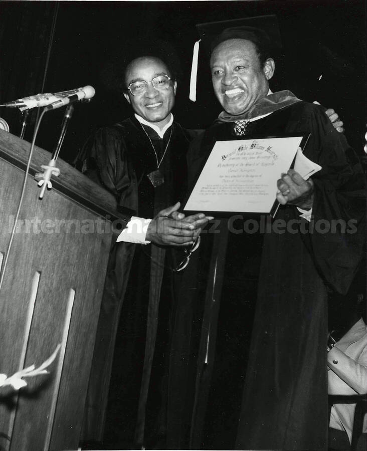 10 x 8 inch photograph. Lionel Hampton in graduation garb receives the degree of Doctor of Humanities from a university [Daniel Gale Williams University?]