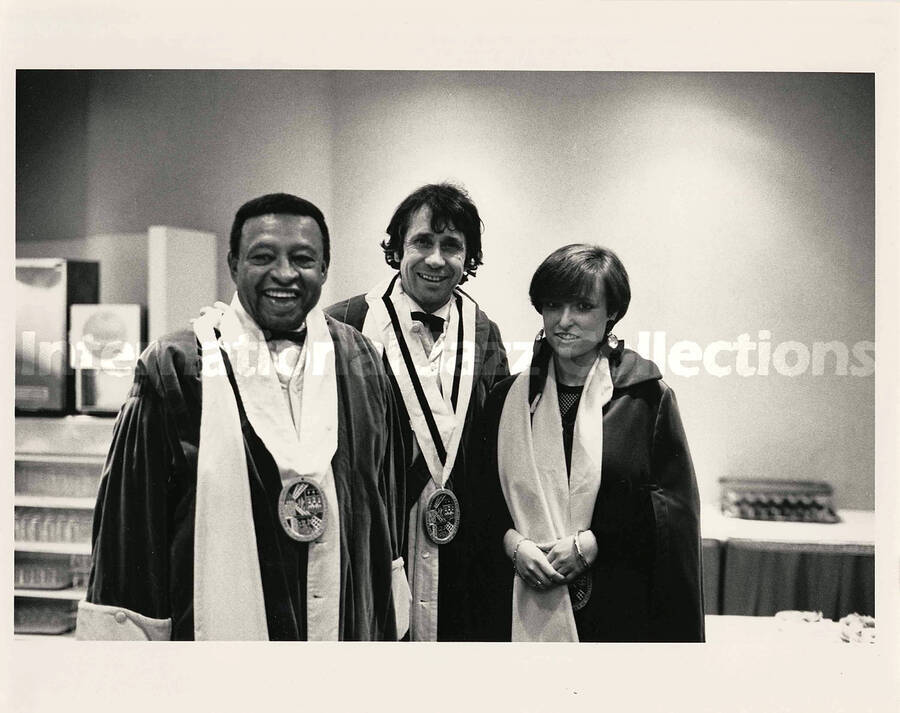 8 x 10 inch photograph. Lionel Hampton with a medal on his neck poses with unidentified man and woman, whom received the same award