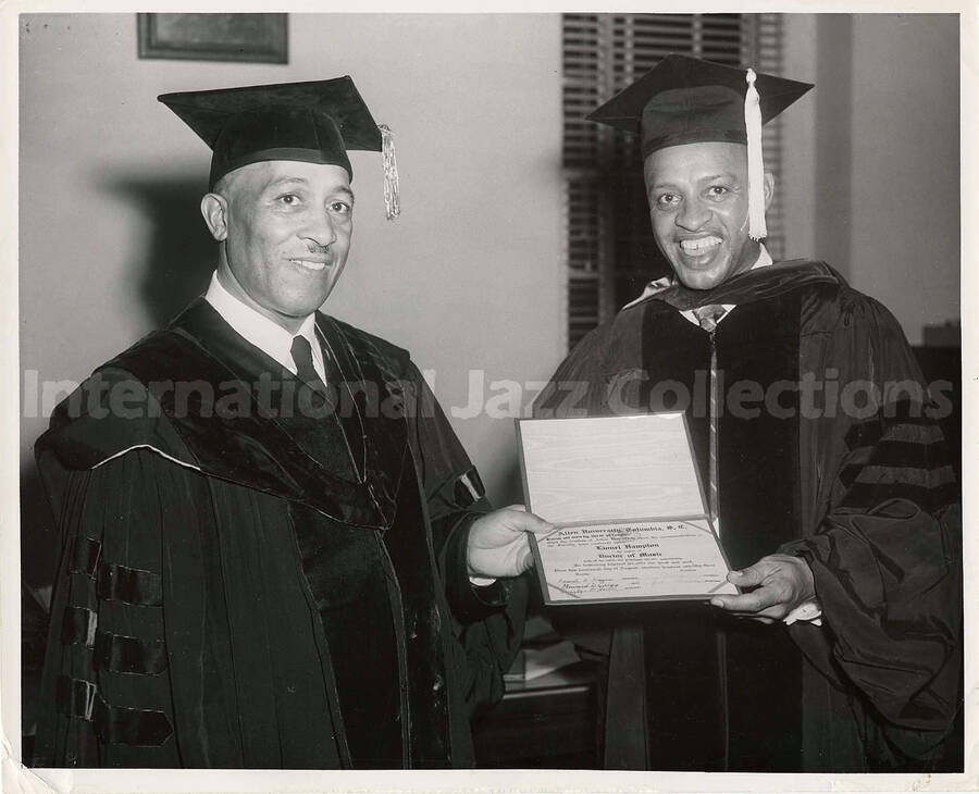 8 x 10 inch photograph. Lionel Hampton receives the degree of Doctor of Music by the Allen University from Bishop Frank Madison Reid. Columbia, SC