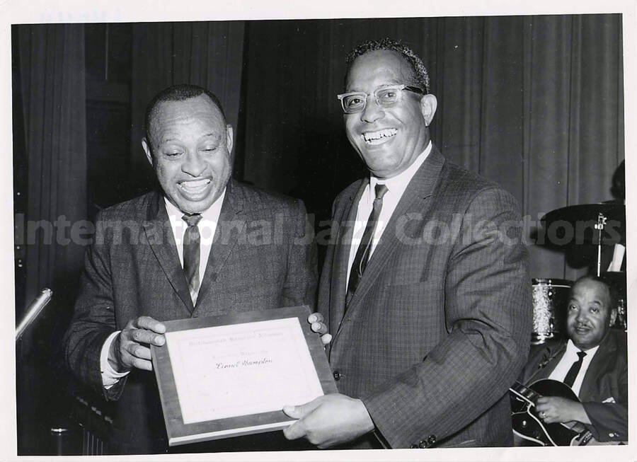 5 x 7 inch photograph. Lionel Hampton receives the Certificate of Distinguished Honorary Alumnus from Langston University for outstanding performance in the field of the performing arts. Langston, OK