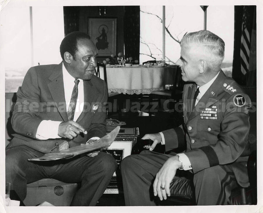 8 x 10 inch photograph. Lionel Hampton with an US Army official wearing the insignia of the Ryukyu Islands (the torii), in Japan