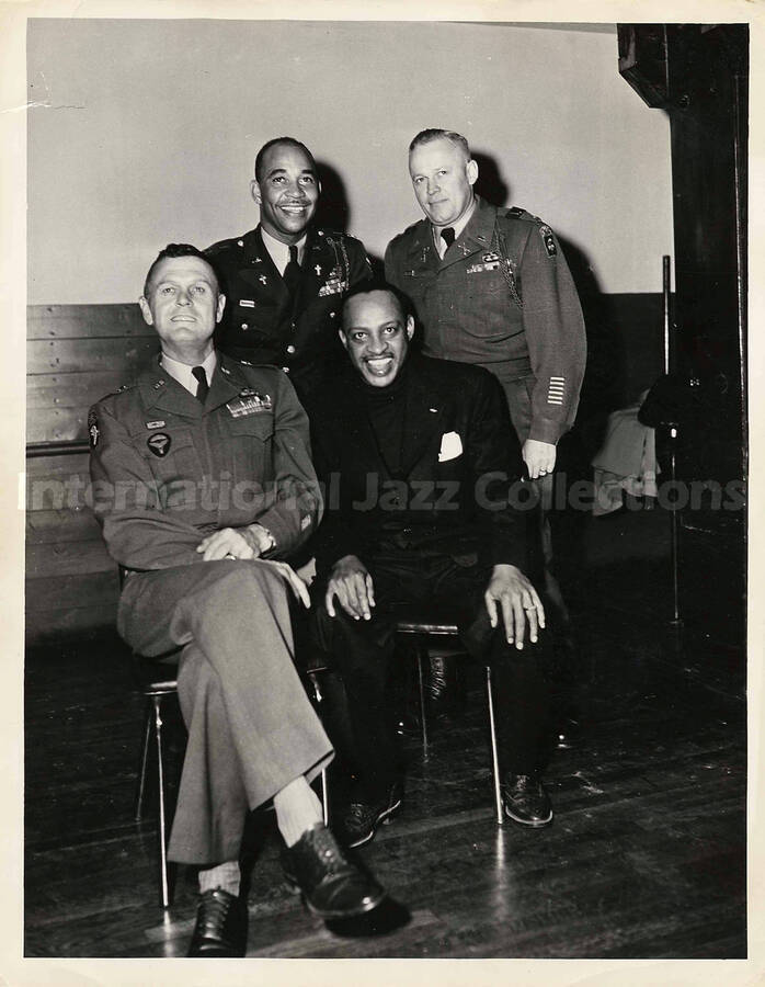 10 x 8 inch photograph. Lionel Hampton with unidentified military men. On the men's shoulder is the AA patch of the 82nd Airborne division