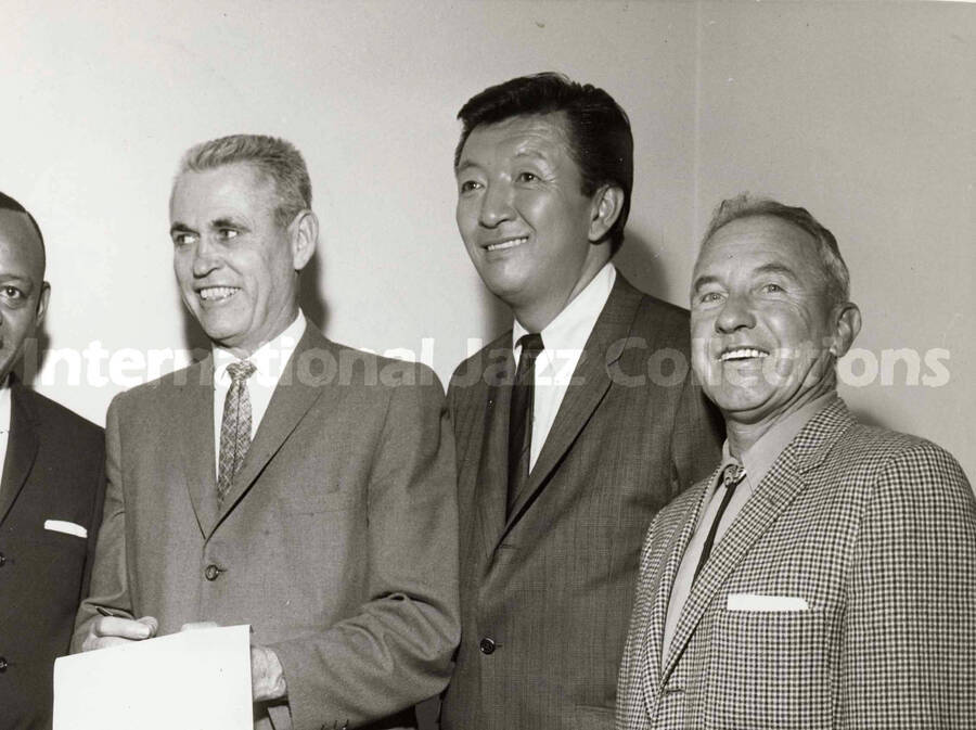 8 x 10 inch photograph. Major Oran Gragson signs the proclamation of the Variety Week in Las Vegas. From left to right Lionel Hampton, Oran Gragson, Jack Soo, and an unidentified man