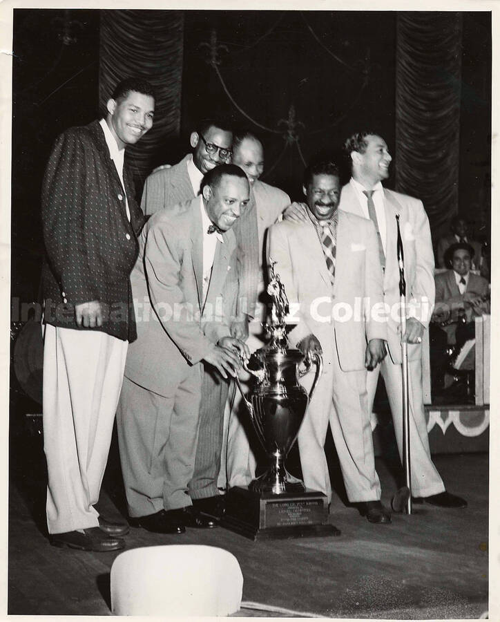 10 x 8 inch photograph. Lionel Hampton with five unidentified men standing around a trophy that reads: The Lord Calvert Award; Pittsburgh Courier
