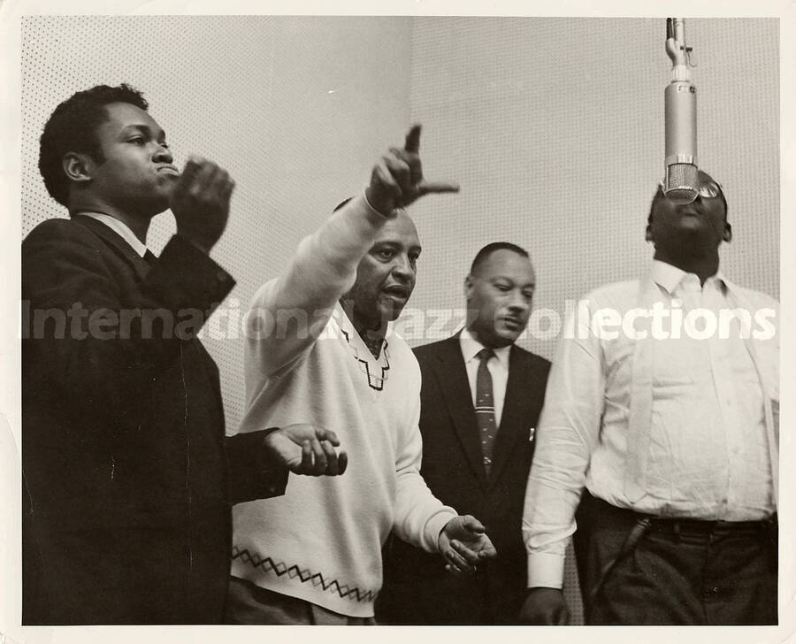 8 x 10 inch photograph. Lionel Hampton with three unidentified men in a recording studio