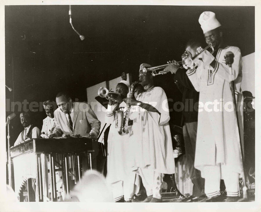 8 x 10 inch photograph. Lionel Hampton performing with unidentified group wearing ethnic costume, probably from an African country