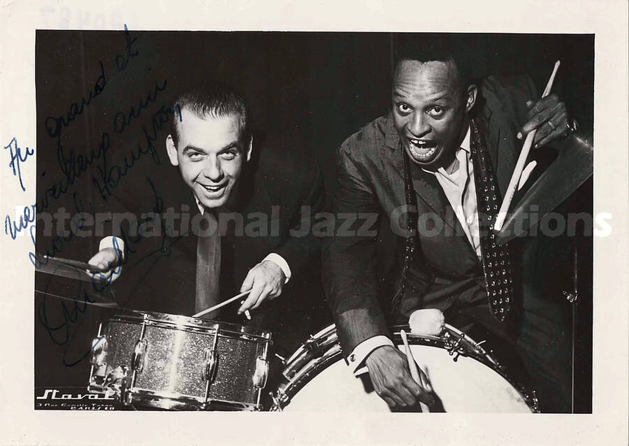 5 x 7 inch photograph. Lionel Hampton with unidentified man [in Paris, France]. This photograph has a dedication in French to Lionel Hampton from Maillard[?]