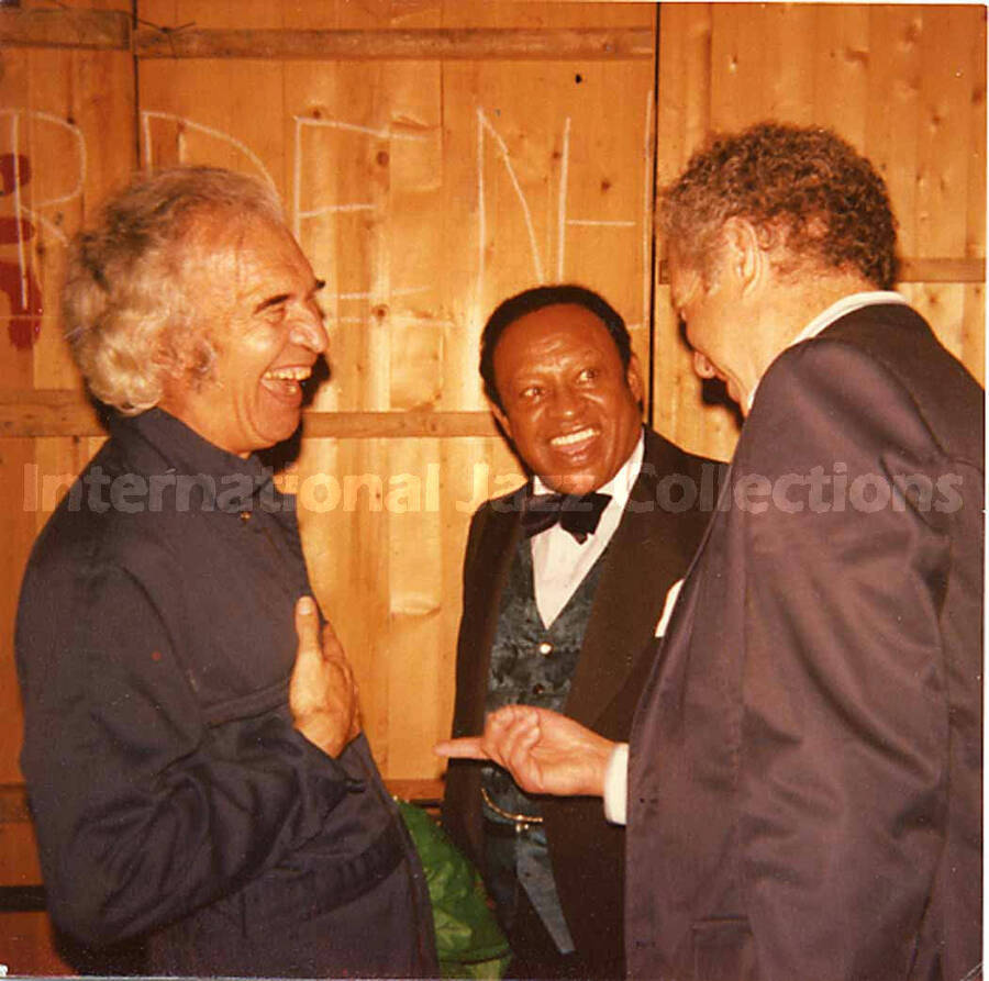 3 1/2 x 3 1/2 inch photograph. Lionel Hampton with Dave Brubeck and an unidentified man
