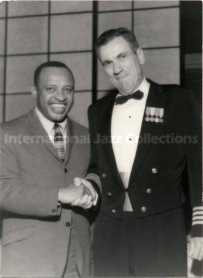 7 1/2 x 5 1/2 inch photograph. Lionel Hampton with unidentified man. This photograph is stamped on the back with [Japanese characters?]